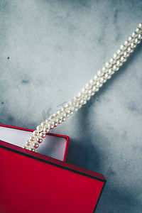 红色礼盒中的精美珍珠、奢华礼物 — 珠宝和她风格概念的奢华礼物