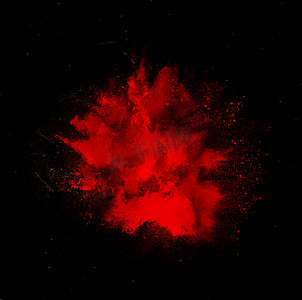 孤立在黑色背景上的红色洒红节油漆粉末爆炸
