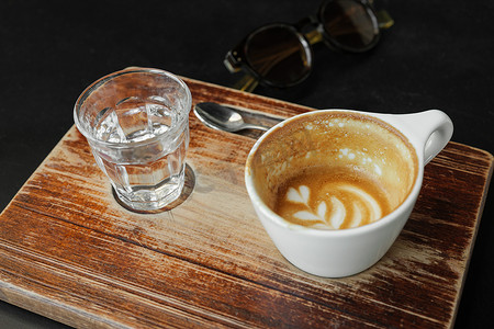 老式咖啡馆木板上的白咖啡杯里的咖啡渍几乎空了