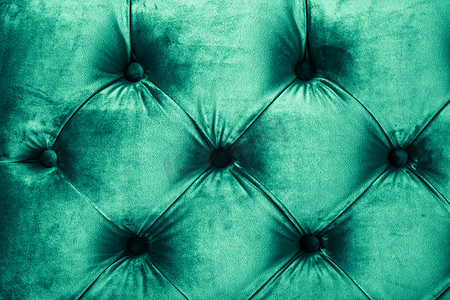 翡翠豪华天鹅绒绗缝沙发内饰，配有按钮、优雅的绿色家居装饰质感和背景