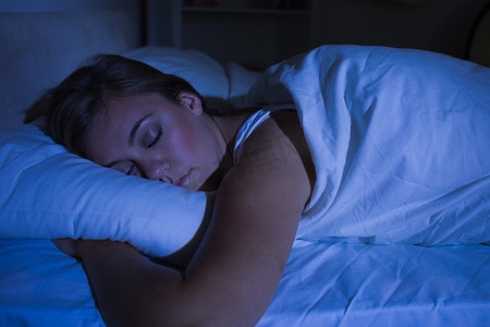 睡觉的枕头摄影照片_晚上睡觉的金发女人