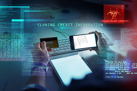 计算机黑客在克隆银行账户时持有信用卡和手机，从而引发网络安全、黑客攻击和欺诈。