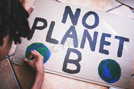 地球日海报摄影照片_抗议气候变化、全球变暖和地球日的环境、纸板和海报。