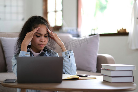 在家工作，年轻的亚洲女性与笔记本电脑作斗争，沮丧的亚洲女孩在学习在线课程、在线业务、电子学习时看着笔记本电脑，人们与技术作斗争