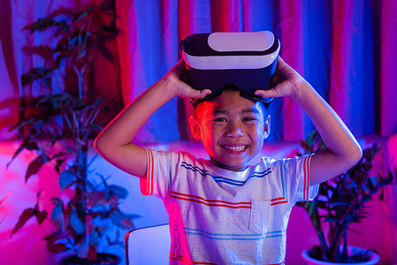 虚拟现实现实摄影照片_体验虚拟现实护目镜的小男孩体验现实