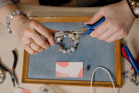 珠宝折扣卡摄影照片_珠宝制作和串珠工艺。时尚、创意和手工制作概念