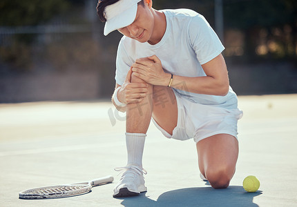 运动员男子在室外球场的比赛中抱膝运动、疼痛和网球损伤。
