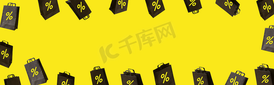 带有黑色销售购物袋的横幅在黄色背景上飘扬。