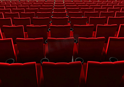 一排排红色天鹅绒座椅在电影院看电影，带有复制空间横幅背景。