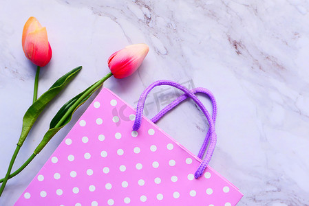 粉色礼品盒和桌上鲜花的顶视图