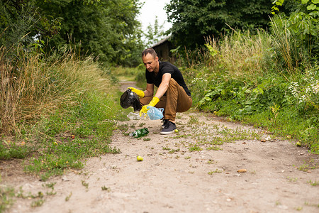 年轻志愿者在公园捡塑料瓶