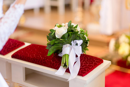 成婚摄影照片_婚礼花束躺在教堂的长椅上