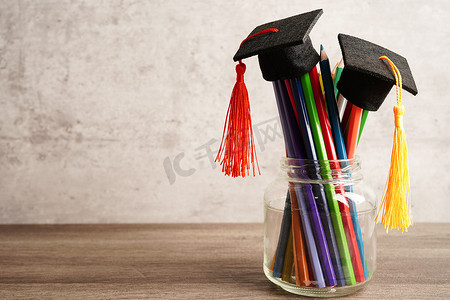 毕业帽上有彩色铅笔，书上有复制空间，学习大学教育理念。