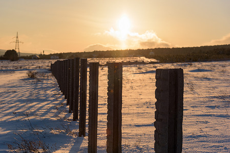 冬季日落景观雪覆盖的乡村田野。