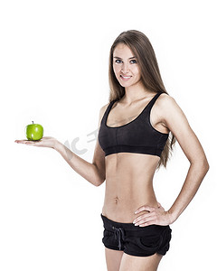 健康生活方式的概念：手里拿着苹果的女健身教练的画像