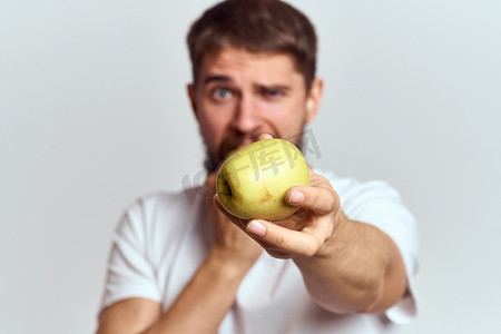 精力充沛的男人，带着苹果健康维生素饮食和生活方式的白色 T 恤裁剪视图