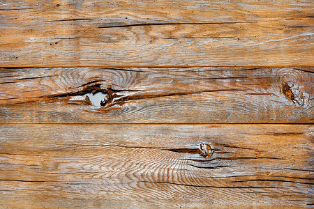 木材质地摄影照片_一块非常古老的破裂板的质地，上面有结点、磨损和灰色油漆。