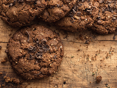 巧克力木板摄影照片_巧克力燕麦饼干洒在木板上