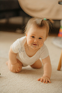 一个 7 个月大的女孩跪着，一只手扶着地毯