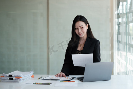 亚洲女商人或会计师在办公桌、账户、审计和储蓄概念上有文书工作。