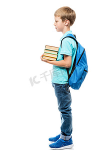 男孩子摄影照片_拿着一堆书和一个背包在白色 backgr 上的男学生
