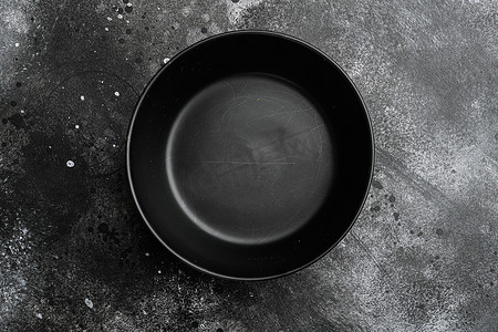 空黑碗，有文字或食物的复制空间，有文字或食物的复制空间，顶视图平躺，黑色深石桌背景