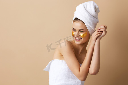 漂亮女人脸上有金色斑块，头上有毛巾特写生活方式