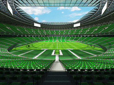 大型美丽的现代橄榄球体育场，配有绿色座椅和 VIP 包厢
