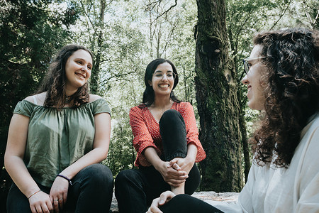 地里摄影照片_3 名年轻女子在森林里互相交谈，参加一个朋友，关心和友谊的概念，爱，讨论