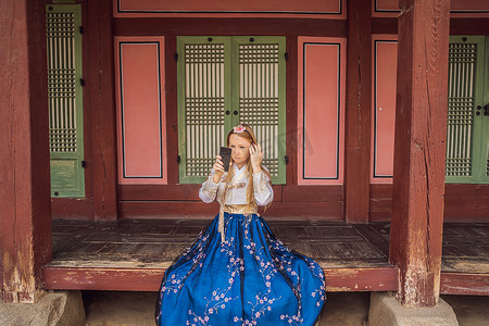 在韩国宫殿穿着韩服的年轻白人女游客。
