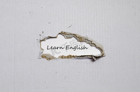 教室标牌摄影照片_这个词出现在撕破的纸后面学习英语