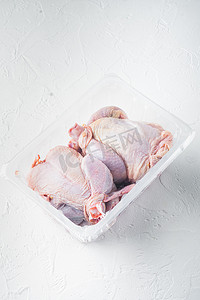 塑料密封盒中的生鸡肉，白色背景，带文本复制空间