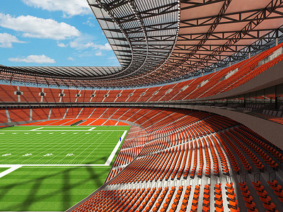 有橙色座位和贵宾包厢的大型美丽的现代美式橄榄球场