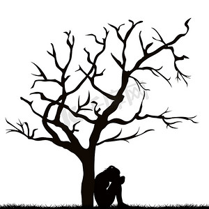 一个悲伤的女人在一棵光秃秃的树下的剪影