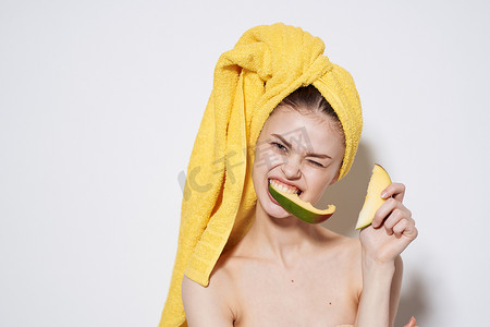 热带水果黄芒果摄影照片_头戴芒果异国维生素水果的裸肩黄毛巾女人