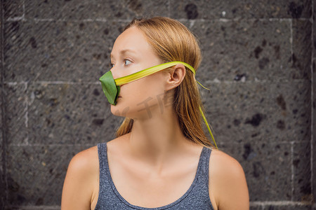 女人用树叶给自己做了一个口罩，以保护自己免受空气污染。