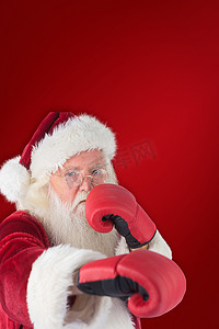 红拳摄影照片_圣诞老人用右手出拳的复合图像