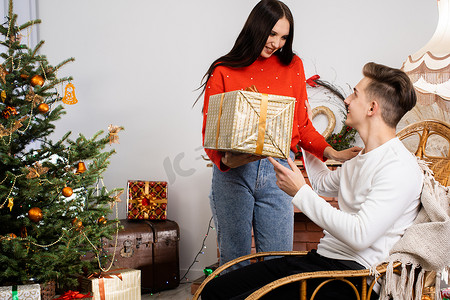 圣诞节气氛摄影照片_未婚夫在圣诞节给她的情人一份礼物。