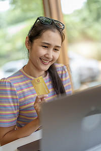 在线购物和互联网支付，美丽的亚洲女性肖像正在使用信用卡和手机在线购物或在数字世界中办事