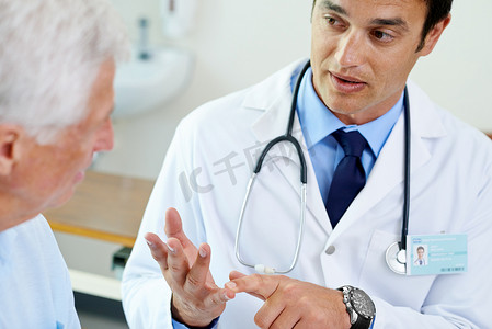 确保他的病人理解……一位英俊的年轻医生向一位年长的病人解释情况的镜头。