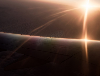 太阳初升摄影照片_初升的太阳和飞机机翼的光线