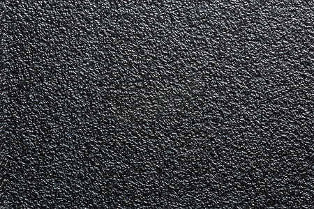 平坦的黑色粗糙塑料或橡胶表面，具有装饰性凹凸饰面