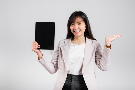 快乐的女性展示空白屏幕数字平板电脑，并在空的手掌上展示产品