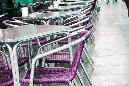 空荡荡的欧洲街头咖啡馆，配有紫色桌椅，有选择的焦点