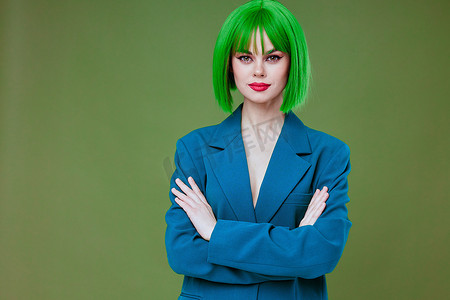 漂亮的年轻女性迷人的绿色假发蓝色夹克摆出绿色背景不变