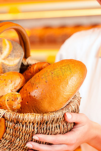 面包店的女面包师用篮子卖面包