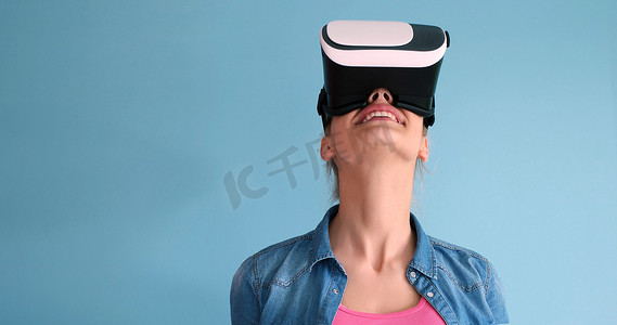 虚拟现实现实摄影照片_使用虚拟现实 VR 耳机眼镜的女性
