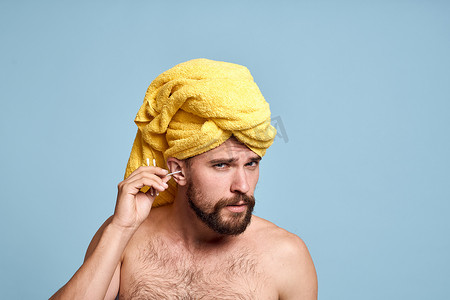 棉鼠摄影照片_裸肩男子头戴黄毛巾棉签卫生护理