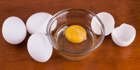 碎鸡蛋摄影照片_玻璃碗里的碎鸡蛋，里面有全蛋和壳