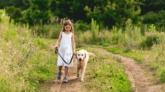 狗跑摄影照片_可爱的小女孩带着狗跑